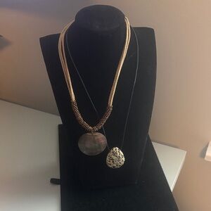 2 BOHO necklaces with pendants in cream and bronze with cloth strands.